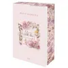 A pink box with floral designs and text. Voir les images du produit