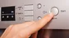 A hand presses a button on a dishwasher control panel. Náhľad obrázku produktu