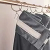 A close-up view of gray velvet curtains hanging from a metal curtain rod. Produktbild-Vorschau