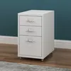 A white three-drawer filing cabinet on wheels, placed on a wooden floor in front of a teal wall. Voir les images du produit