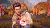 A woman in a futuristic outfit holds a weapon in a barren, alien landscape. Produktbild-Vorschau