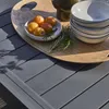 A close-up view of a garden table with a tray of fruit and bowls. Anteprima dell’immagine prodotto