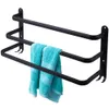 A black metal towel rack with three bars, holding two turquoise towels. Voir les images du produit