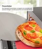 A pizza being slid out of an oven with a pizza peel. Anteprima dell’immagine prodotto