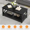 A black coffee table with decorative items and storage baskets on a rug in a living room setting. Produktbild-Vorschau