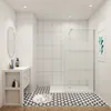 A modern bathroom with a walk-in shower, vanity, and patterned floor. Produktbild-Vorschau