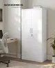 A white metal storage cabinet in an office setting, with a desk and chair visible. Náhled obrázku produktu