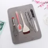 Kitchen utensils laid out on a grey drying mat. Produktbild-Vorschau