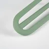 A close-up shot of the curved end of three green hairpin legs. Podgląd zdjęcia produktu