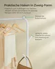 A close-up of a white garment rack with clothes and accessories hanging on it, with descriptive text overlays. Produktbild-Vorschau