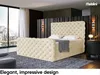 A bedroom scene featuring a large, upholstered bed with a headboard and footboard, a nightstand, and a window with a mountain view. Produktbild-Vorschau
