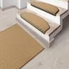 A beige carpet runner and stair treads on a wooden floor and stairs. Produktbild-Vorschau