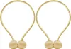 Two gold magnetic curtain tie-backs are shown against a white background. Náhled obrázku produktu