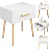 A collage of images showing a white bedside table with a wooden drawer handle and legs. One image shows the drawer open, revealing items inside. Náhľad obrázku produktu