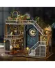 A detailed miniature model of a magical house with a clock tower, stairs, and various rooms filled with potion bottles and decorative items. Náhled obrázku produktu