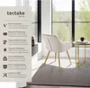 A chair in a room with a large window overlooking a forest. Produktbild-Vorschau