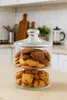 A two-tiered glass jar filled with cookies sits on a kitchen counter. Produktbild-Vorschau