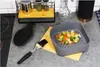 A kitchen counter with cooking accessories and vegetables. Anteprima dell’immagine prodotto