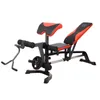 A weight bench with leg extension and curl attachments, and a weight plate on the leg curl mechanism. Produktbild-Vorschau