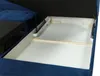 A close-up view of the interior storage compartment of a blue sofa, with the lid open. Náhled obrázku produktu