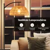 A floor lamp with a woven lampshade is shown in a living room setting, with sofas in the foreground and windows in the background. Overlay text highlights product features. Podgląd zdjęcia produktu