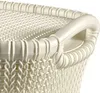 A close-up view of the top edge and handle of a white woven laundry basket. Anteprima dell’immagine prodotto