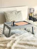 A bed with a tray on it, holding a laptop and a mug. Anteprima dell’immagine prodotto