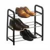 A black metal shoe rack with three shelves, holding six pairs of men's dress shoes and boots. Produktbild-Vorschau