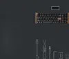 A keyboard and accessories laid out on a dark gray background. Voir les images du produit