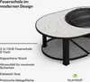 A modern outdoor fire pit with a terrazzo-like tabletop and a black metal frame and legs, shown from a slightly elevated side angle. Text overlays describe its features. Produktbild-Vorschau