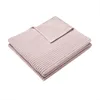 A folded pink blanket with a ribbed texture is shown against a white background. Produktbild-Vorschau