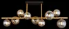 A modern chandelier with multiple glass globes suspended from a black rectangular base. Náhled obrázku produktu