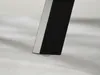 Close-up of the bottom of a black table leg with a silver accent and a small white foot. Anteprima dell’immagine prodotto