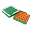 A capsule filling tool with a base plate containing many small holes and a lid with a grid pattern. Voir les images du produit