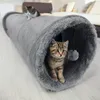 Two kittens playing in a grey fabric tunnel in a living room. Produktbild-Vorschau