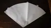 A white coffee filter laid flat on a dark wooden surface, folded into a cone shape. Voir les images du produit