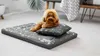 A small dog is resting on a dog bed with a pillow. Náhled obrázku produktu