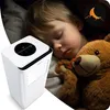 A child sleeping with a teddy bear next to an air purifier. Podgląd zdjęcia produktu