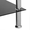 A close-up view of a modern side table with a black glass top and chrome legs. Produktbild-Vorschau