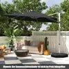 A patio scene with a large black cantilever umbrella providing shade over a sofa and fire pit. Náhled obrázku produktu