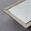 A close-up view of the corner of a diamond-shaped mirror with a silver frame. Produktbild-Vorschau