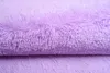 A close-up view of a fluffy, violet rug. Anteprima dell’immagine prodotto