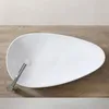 A white basin with a silver faucet on a wooden surface. Náhled obrázku produktu