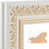 A close-up view of a decorative mirror frame, showing its intricate white and gold baroque-style detailing. Produktbild-Vorschau