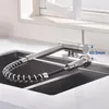A kitchen faucet with a pull-down sprayer is shown installed over a sink, with a measurement indicator. Podgląd zdjęcia produktu