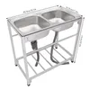 A stainless steel double sink with a stand and shelf, with dimensions indicated by text overlays. Náhled obrázku produktu