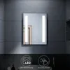 A modern bathroom mirror with integrated LED lighting, displayed against a textured gray tile wall. The bottom of the image features icons and text highlighting product features. Náhled obrázku produktu