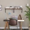 A home office setup with a desk, chair, laptop, lamp, and shelves. Produktbild-Vorschau