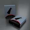Two product boxes for a media remote are displayed on a gray surface. Produktbild-Vorschau