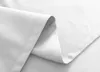 A close-up view of white fabric, showing folds and seams. Produktbild-Vorschau
